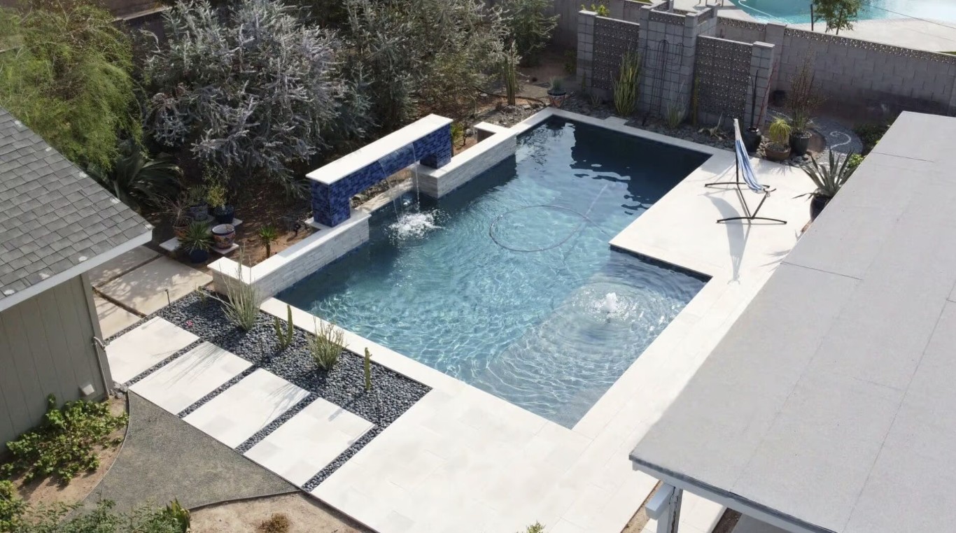 Modern pool with blue tile waterfall feature in Costa Mesa, CA